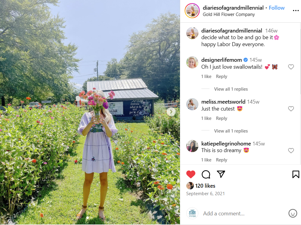 Woman holding bouquet of flowers over face in a field of flowers