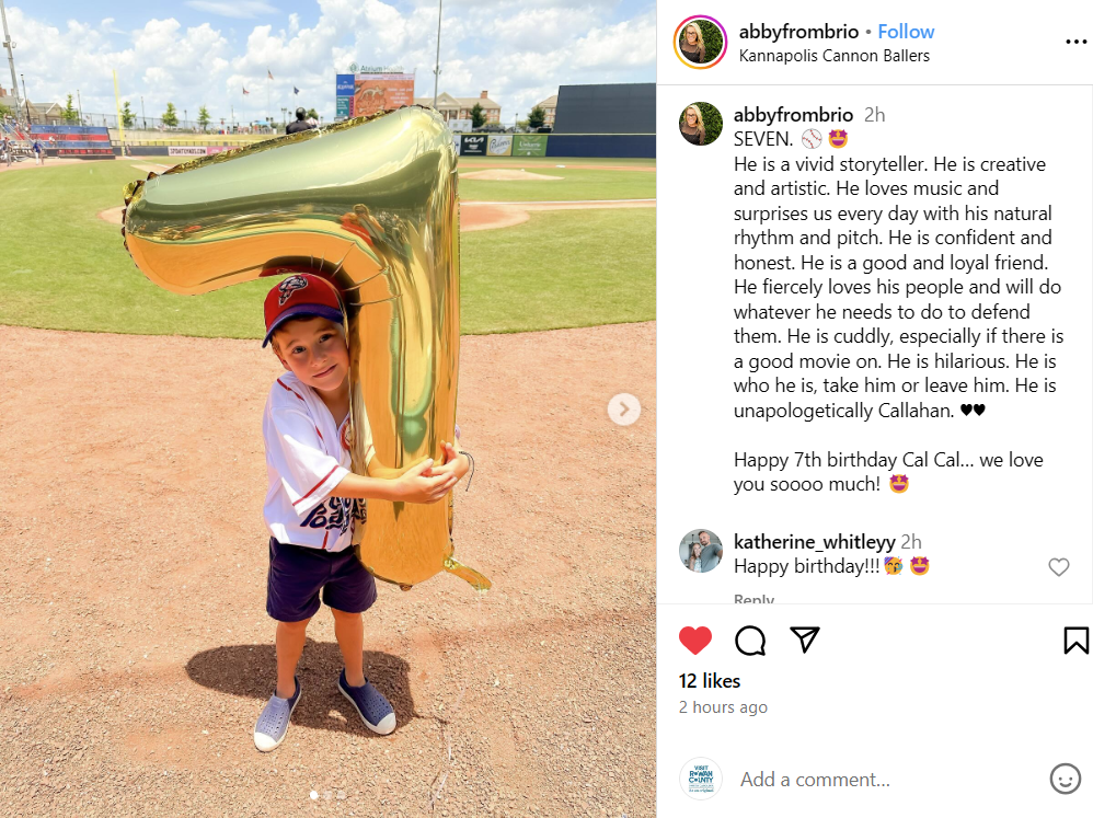 Boy with "7" balloon on baseball field