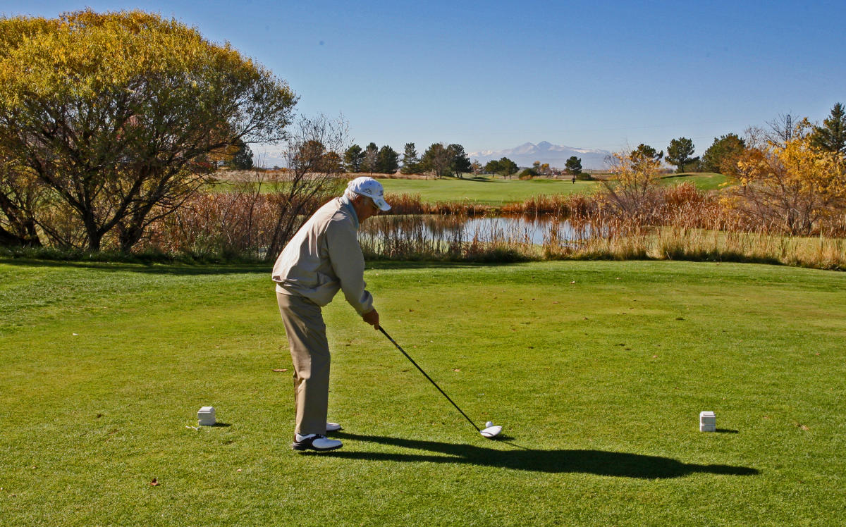 Golfer teeing off