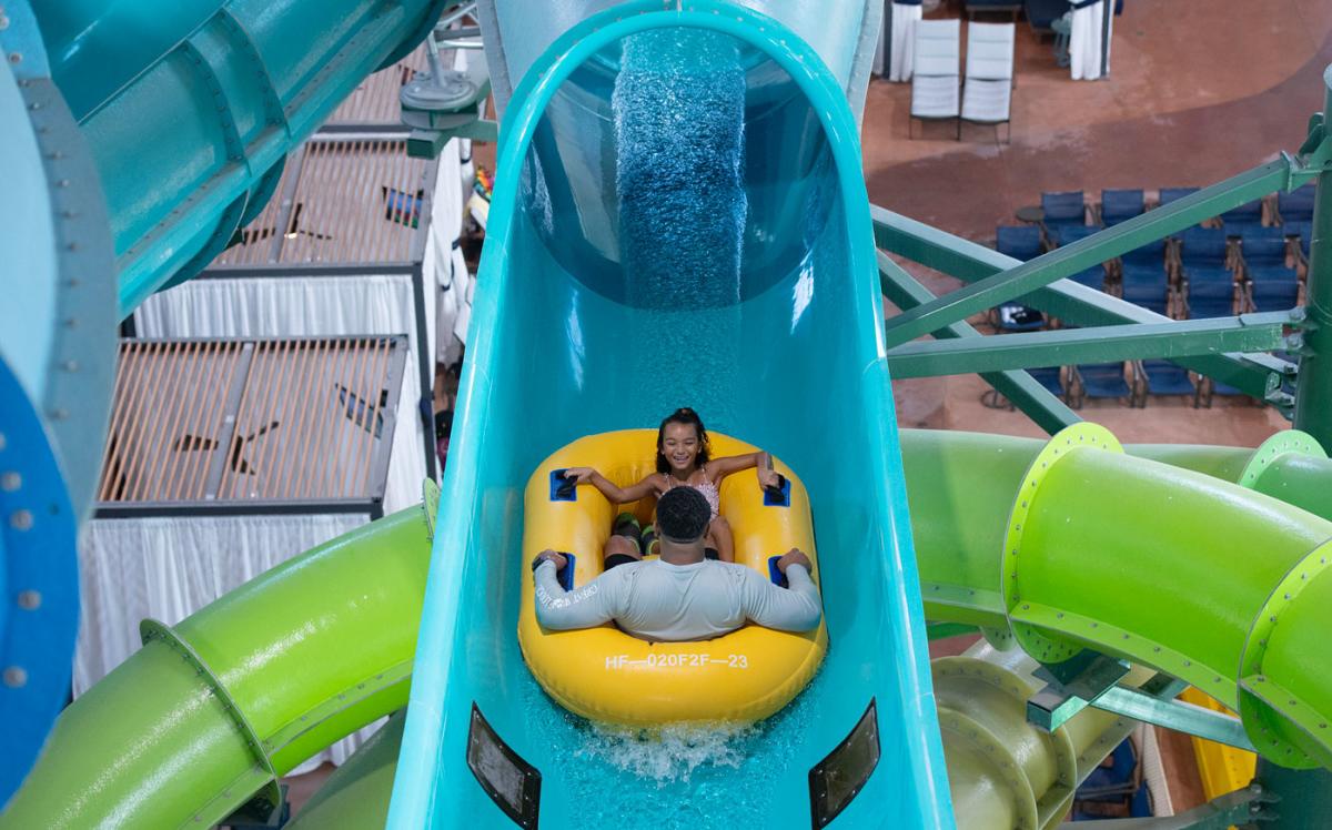Father daughter duo enjoying water tube slide