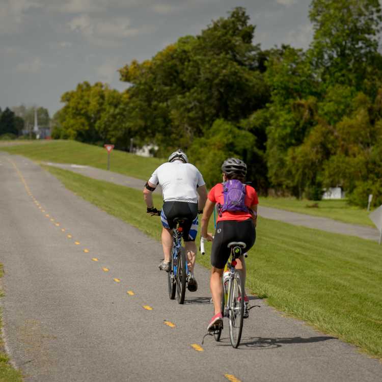 Two men riding bikes on the Levee Bike Path in Kenner, LA