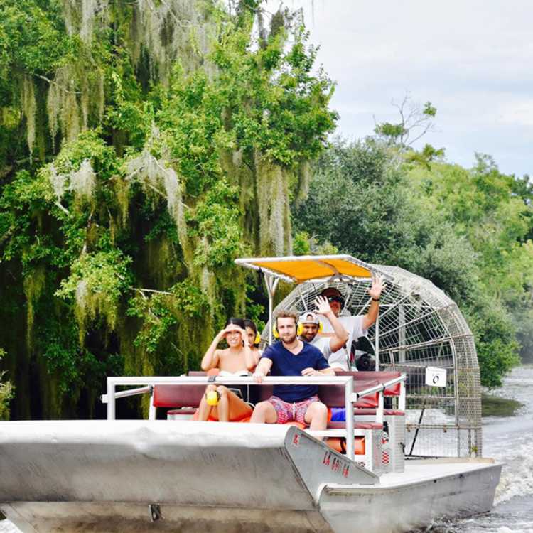 Visitors enjoy an area swamp tour aboard an airboat.