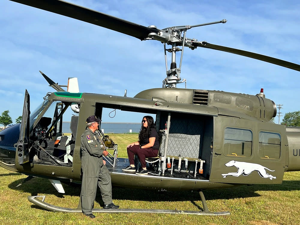 Pilot and passenger on huey helicopter