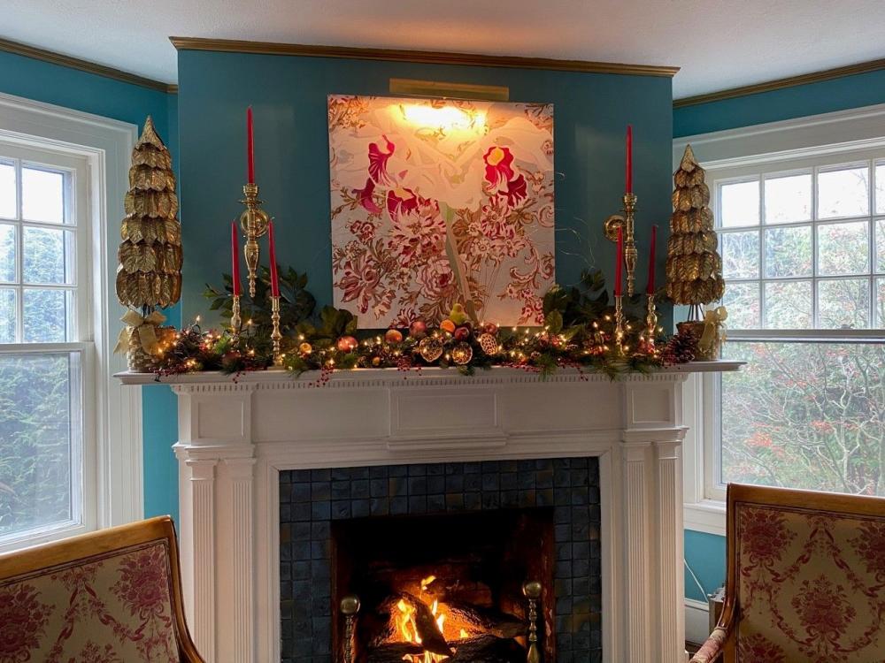 A fireplace mantle decorated for the holidays at the 1889 WhiteGate Inn in Asheville, NC