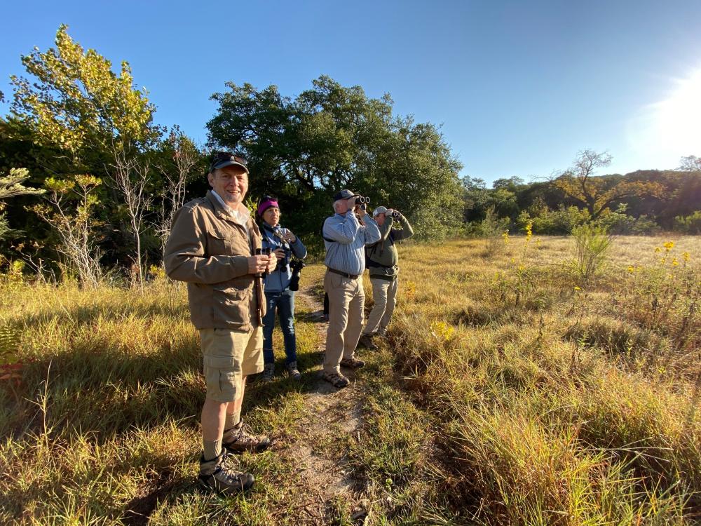 Group of people birding with binoculars at Doeskin Ranch