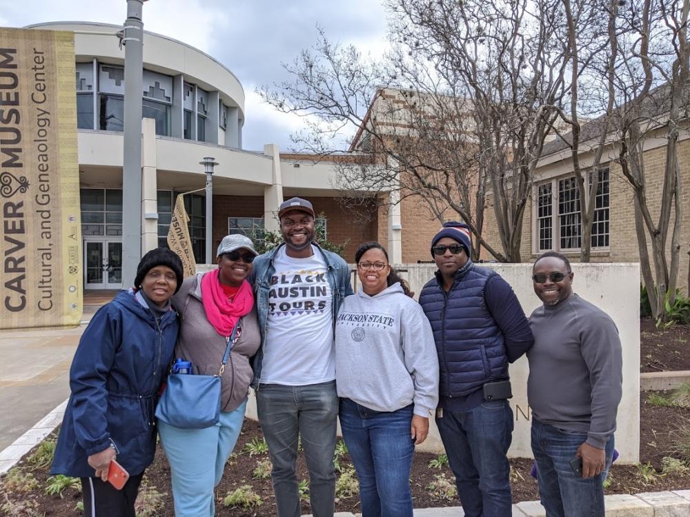 Group of people with Black Austin Tours guide Javier Wallace at the Carver Museum in Austin Texas