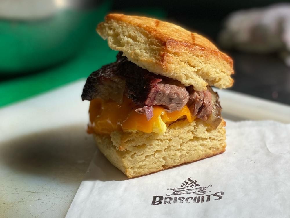 Thick, flaky biscuit sandwich stuffed with brisket slices, eggs and melty cheese.