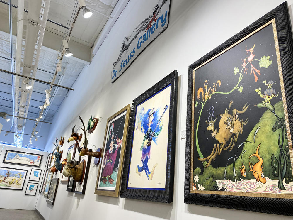 Dr. Seuss art hung in a gallery.