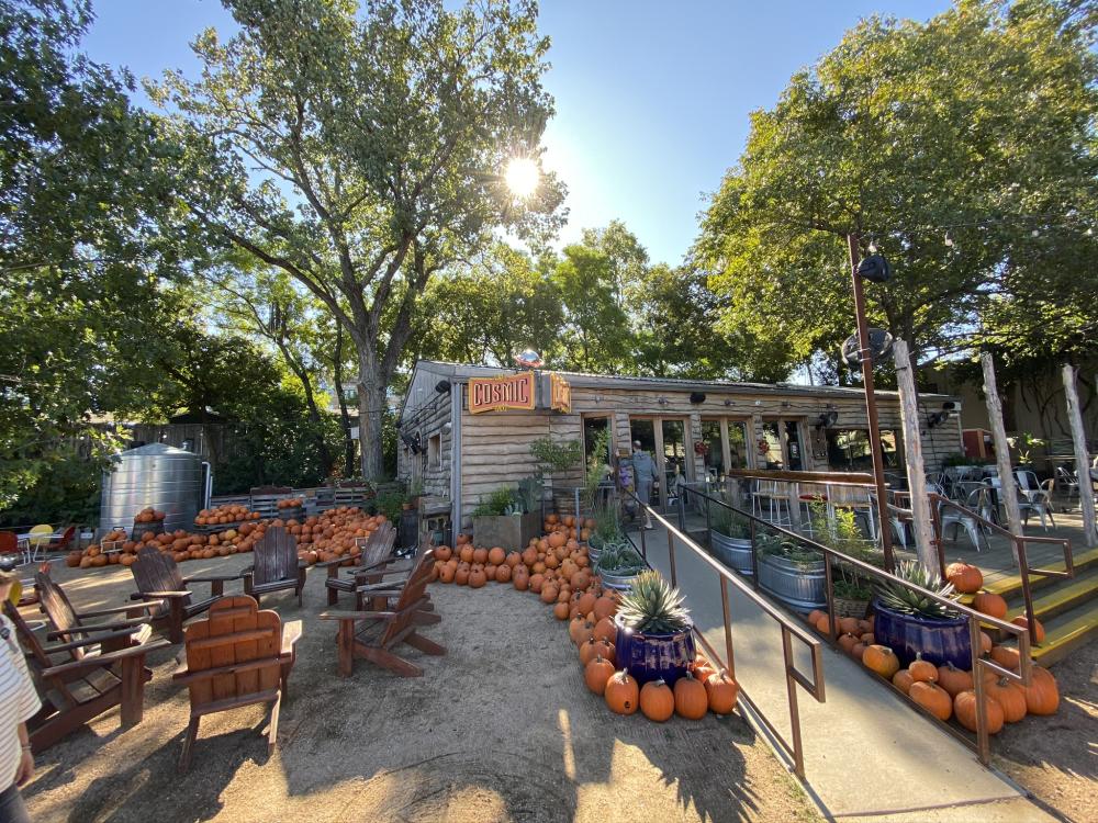 Exterior and patio at Cosmic Coffee and Beer decorated for fall with tons of pumpkins