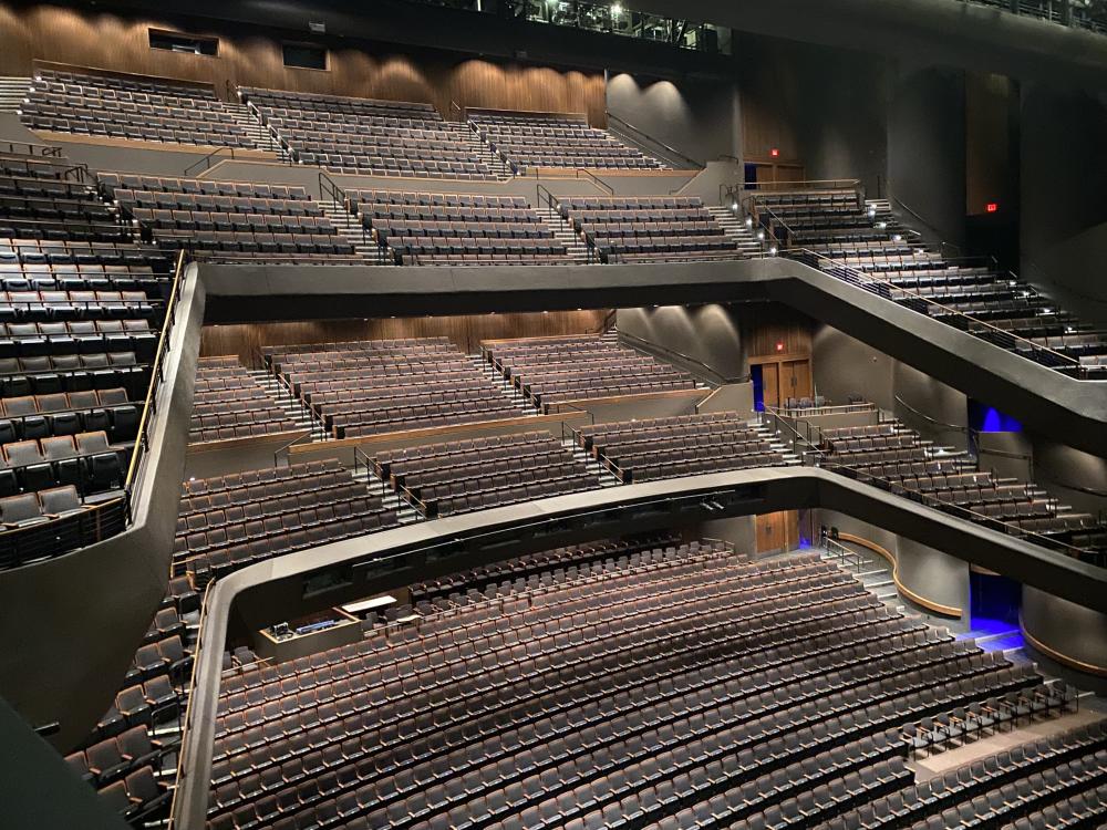 photo of the 2021 renovated interior of Bass Concert Hall. The photo shows three levels of audience seating in the concert hall