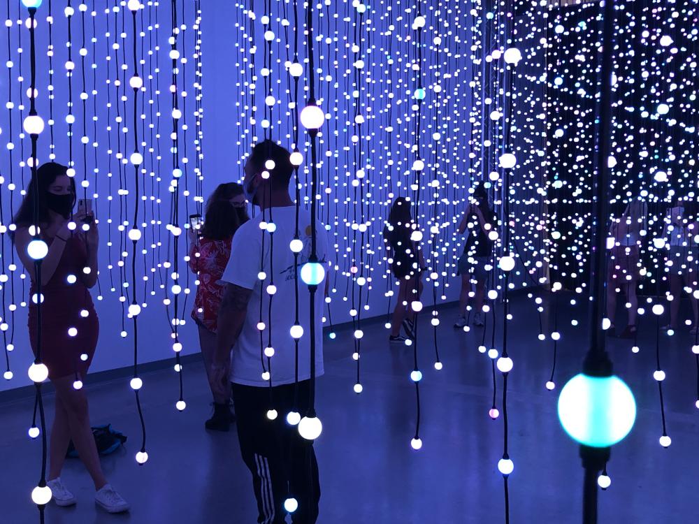 People inside Submergence art installment with lights at Wonderspaces Austin Texas