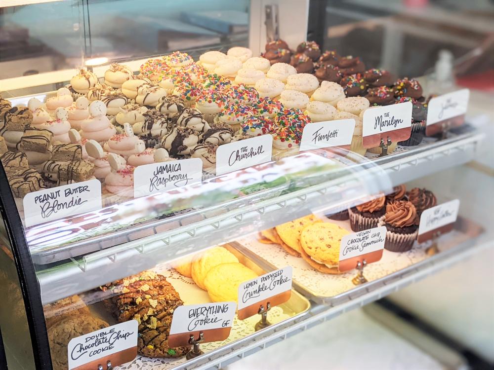 case filled with baked goods like cupcakes and blondies at Sugar Mamas Bake Shop in Austin Texas