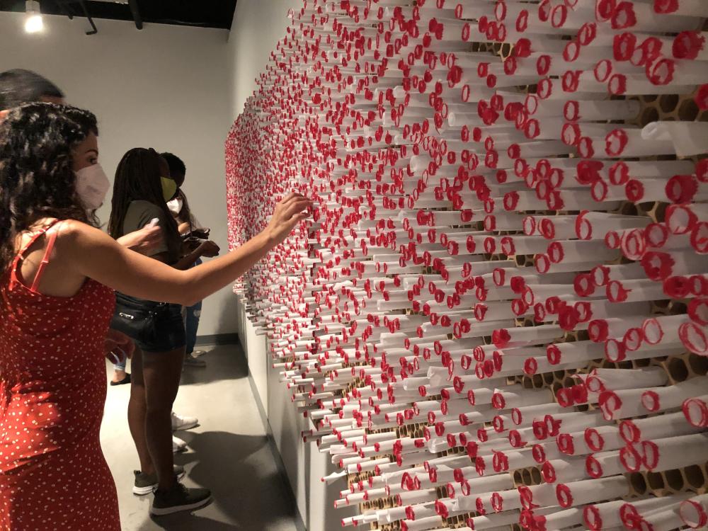 Woman touches The Last Word art installment at Wonderspaces in Austin Texas