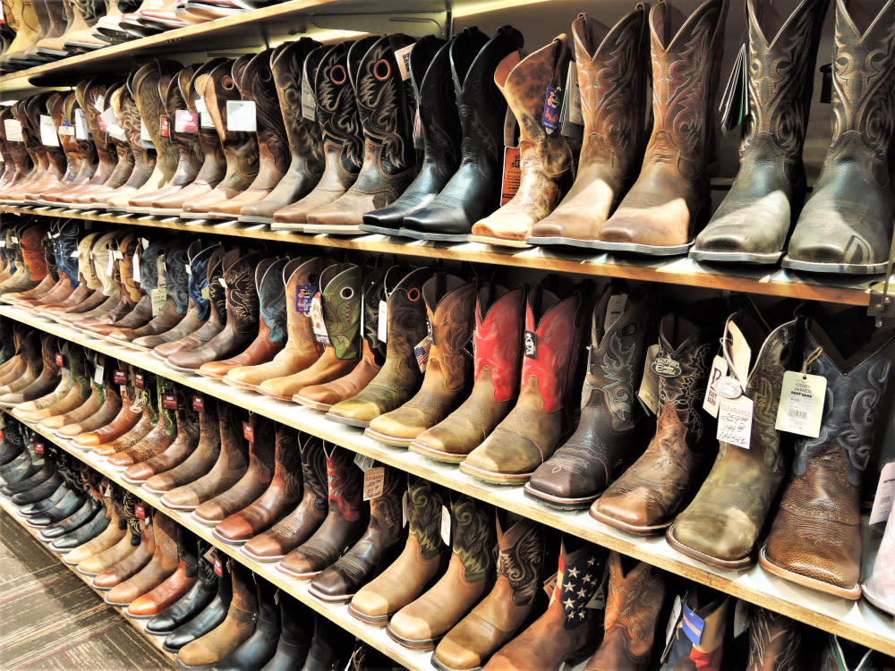 Shelves full of pairs of cowboy boots.