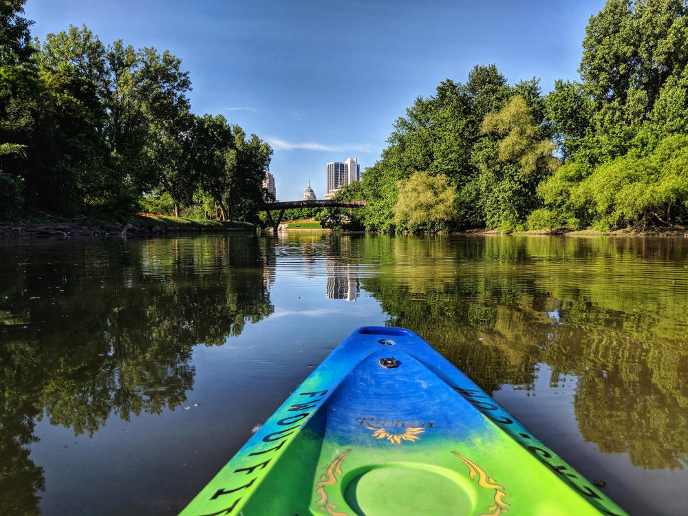 Kayaking Fort Wayne's rivers with a view of the skyline.