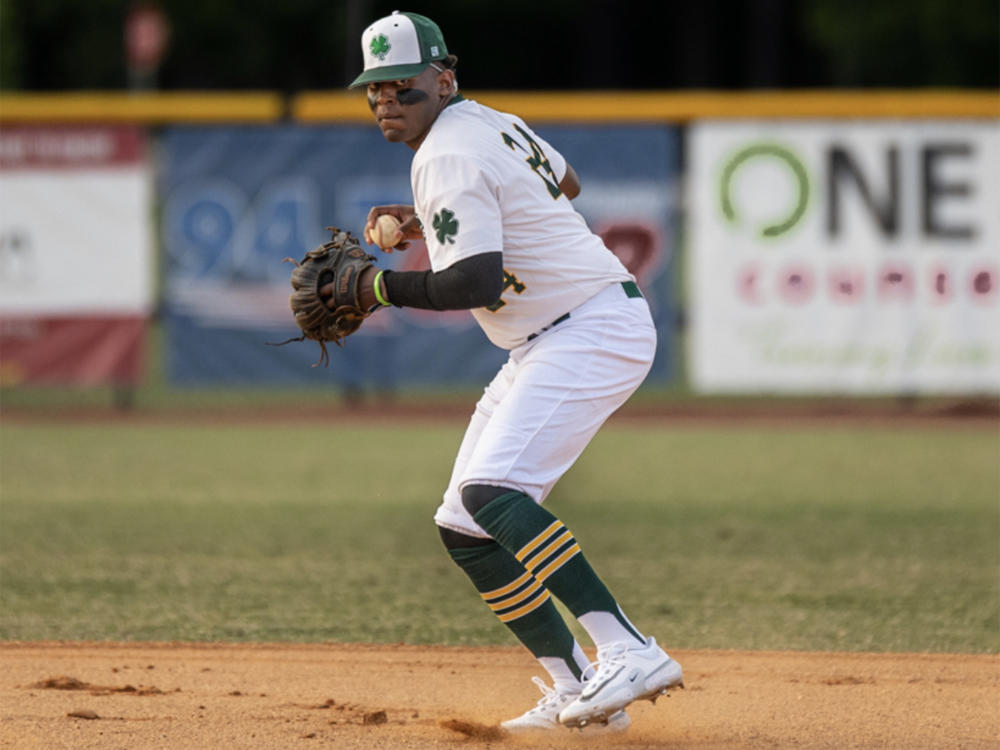 A Clayton Clovers player throws the ball