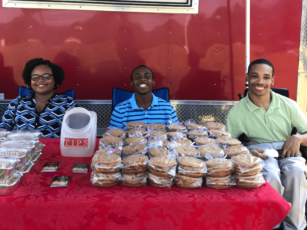 Kookie Krumbs crew outside the food truck selling cookies.