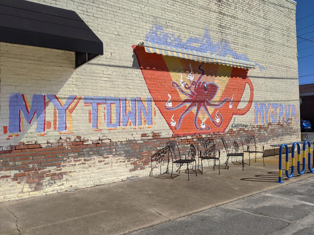 Milltown Java mural in Princeton, NC of an octupus holding coffee and text that says "My Town, My Java"