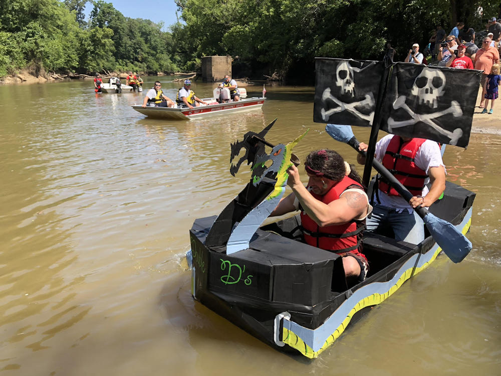 Two Men Attempt to Pilot a Cardboard Boat Down the Neuse River