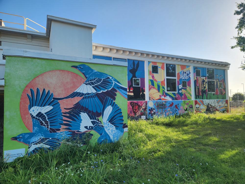 walls covered in colorful murals at MillHouse McKinney in the Cotton Mill