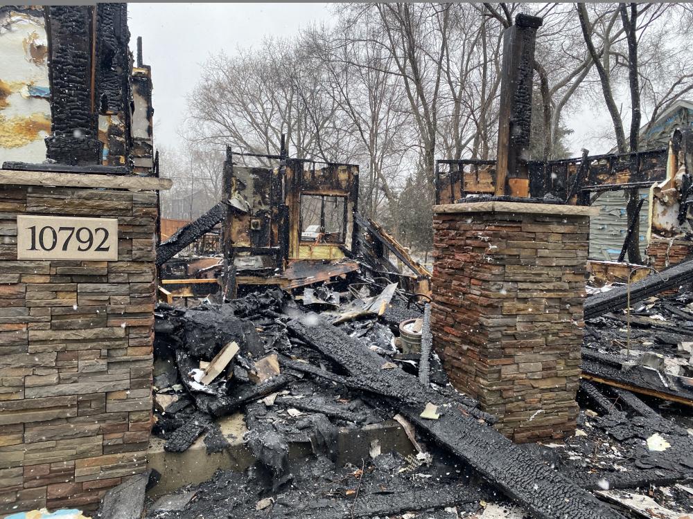 The front of Mary Butler's burned home after a Brooklyn Park, MN plane crash in March 2025