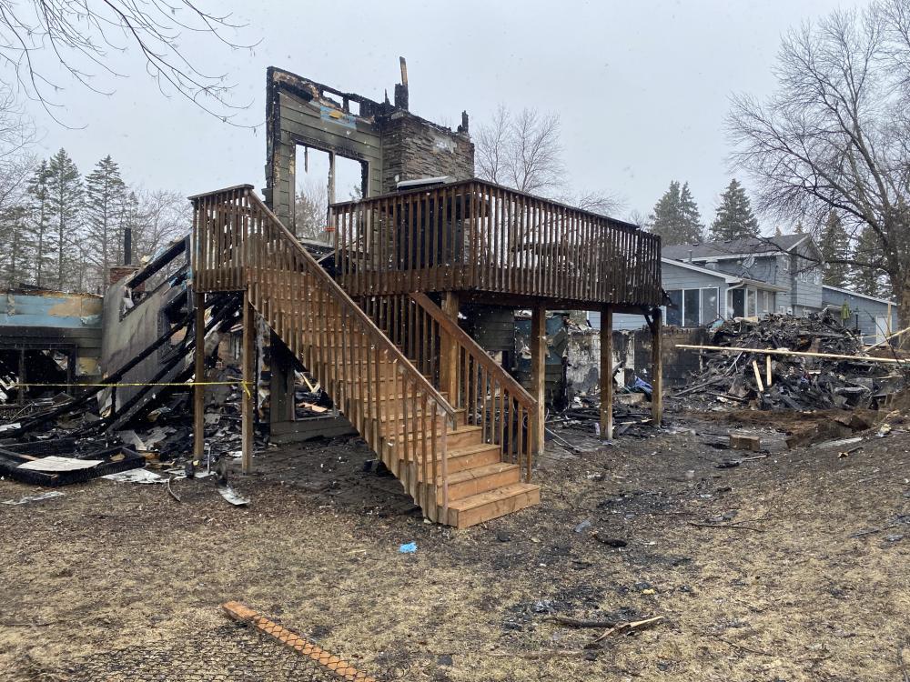 Mary Butler's burned Brooklyn Park, MN home after a plane crashed into it in March 2025