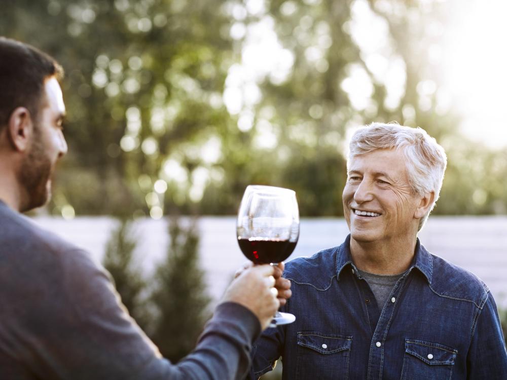 Father and Son Guys Drinking Wine Outside