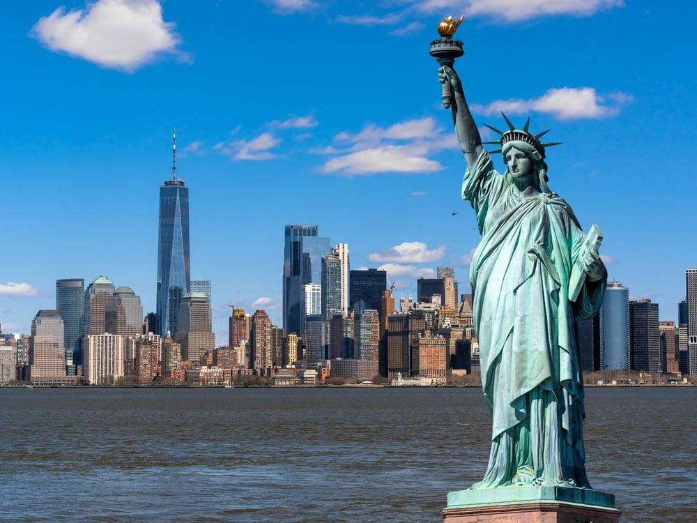 Statue of Liberty with the Lower Manhattan skyline in the background.