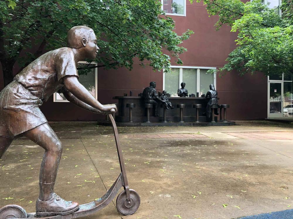 Bronze Sculpture of Sit-in with Boy on Scooter