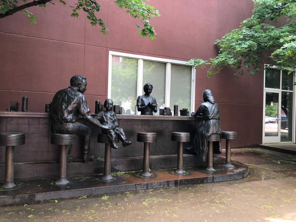 Bronze Sit-in Statue at Chester I. Lewis Reflection Square Park