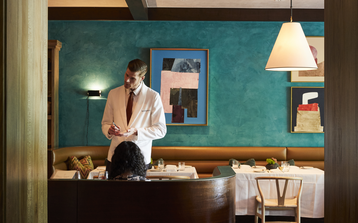 Image of a waiter taking a diners order in the Jeffrey's dining room.