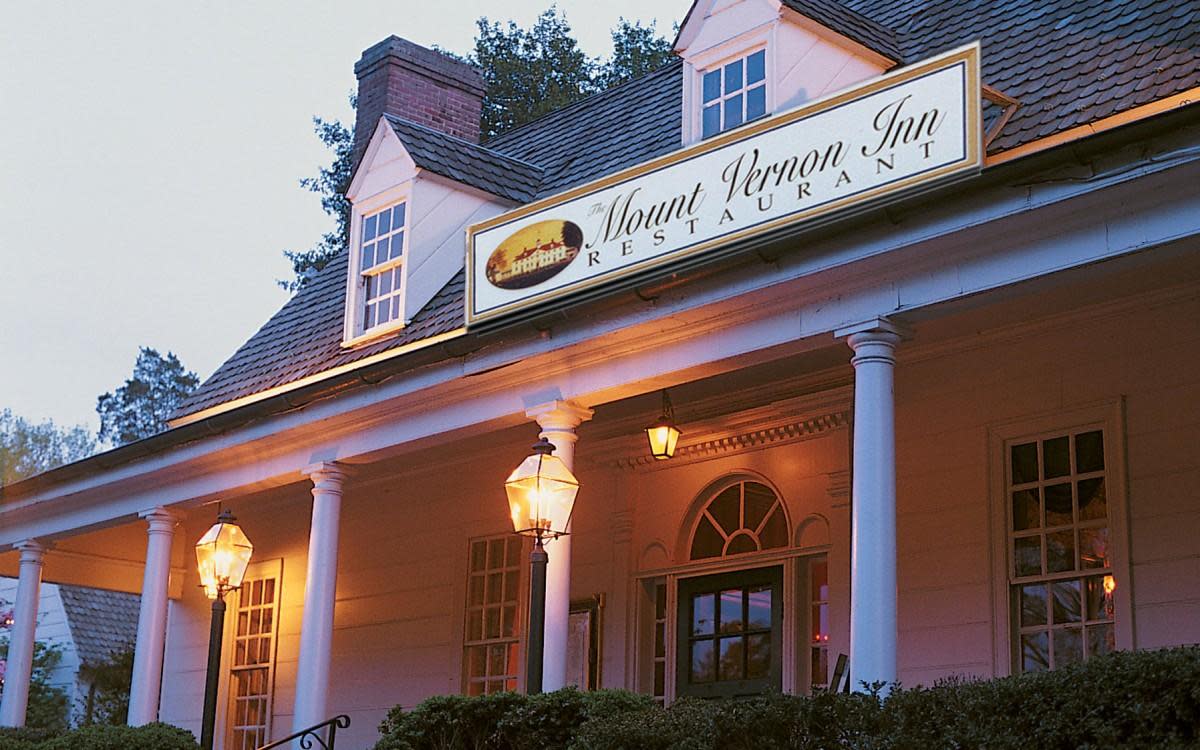 Exterior shot of the Mount Vernon Inn Restaurant in the evening with lanterns lit on the front porch