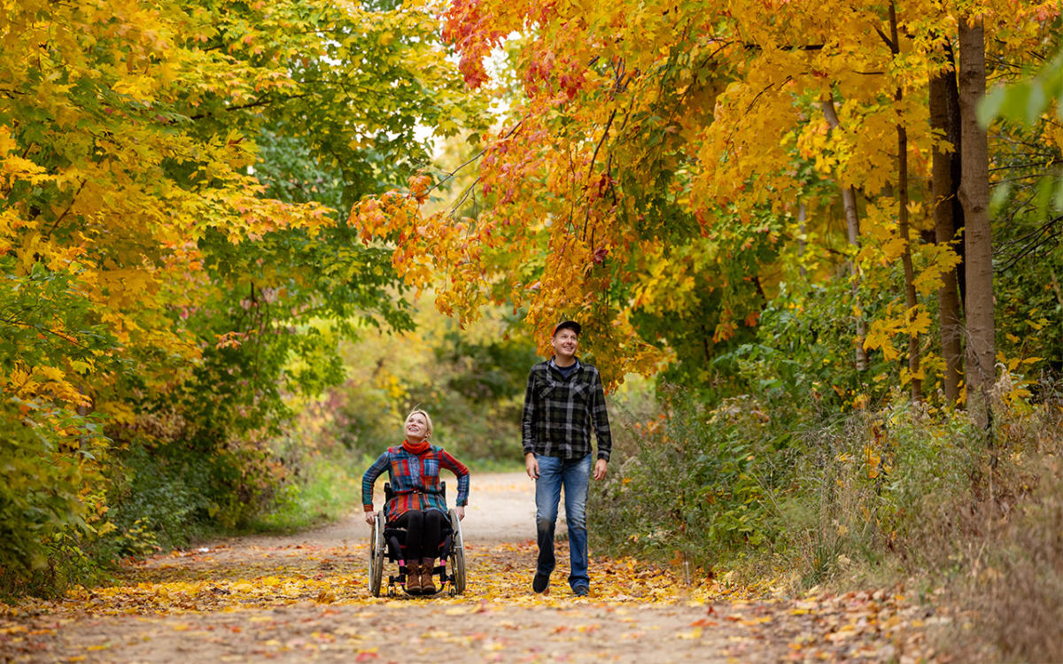 Two people on a fall hike in Madison, WI with colorful leaves