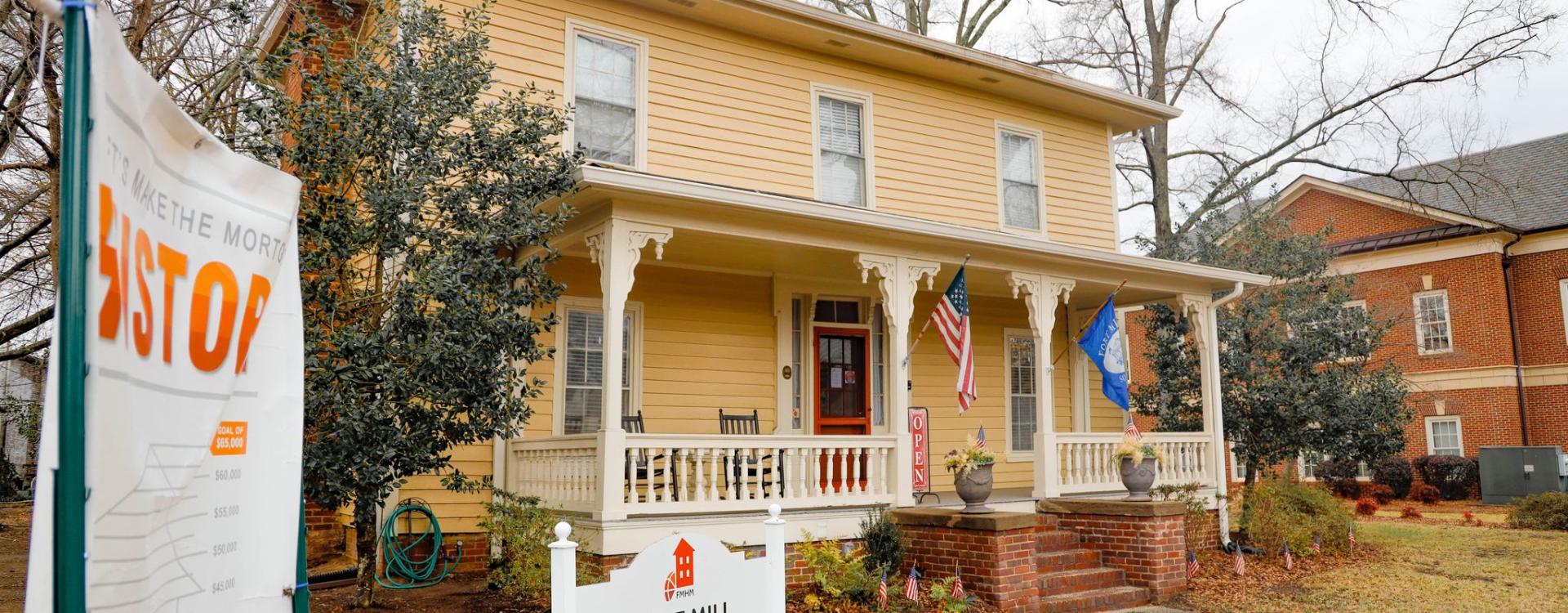 Yellow house and a sign in front of it reading Fort Mill History Museum