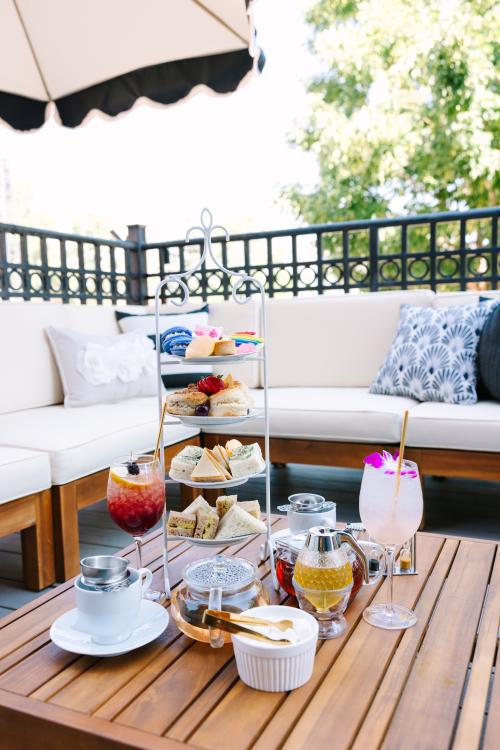 Babe's Tea Room Golden patio with tea service finger foods, tea and drinks