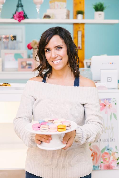 Les Petits Bisous owner holding macaroons