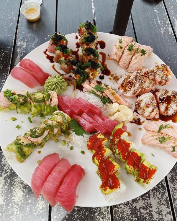 Sushi plate with sashimi and sushi rolls at Japaneiros