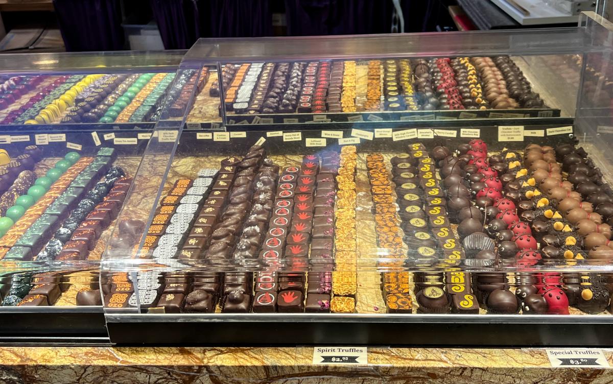 Dozens of chocolates on display in the truffle case at Piece, Love, and Chocolate in Boulder, CO.