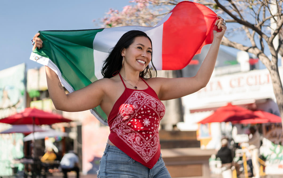 Lady holding Mexican Flag for Cinco de Mayo fiesta