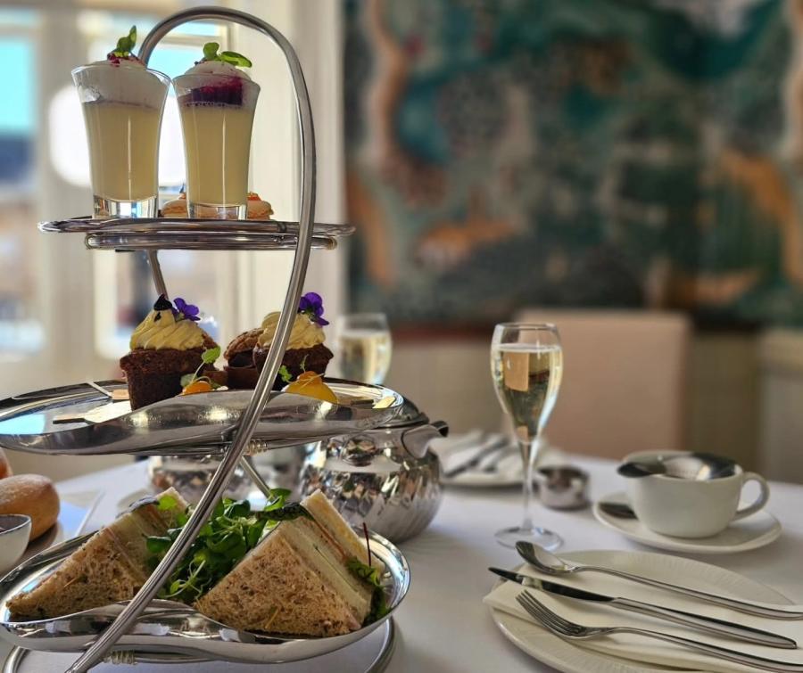 Delicate sandwiches and cakes served with a glass of bubbly at Cotswold House Hotel & Spa