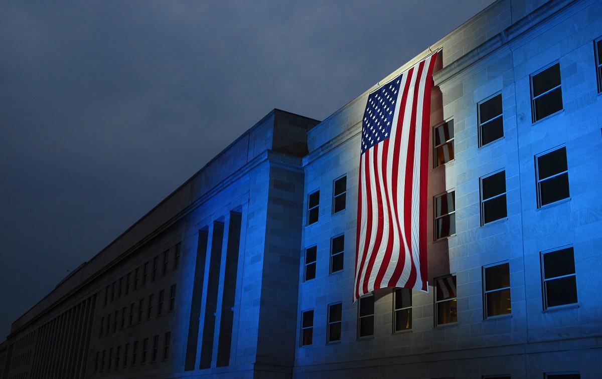 A memorial flag is illuminated near the spot where American Airlines Flight 77 crashed into the Pentagon on Sept. 11, 2001