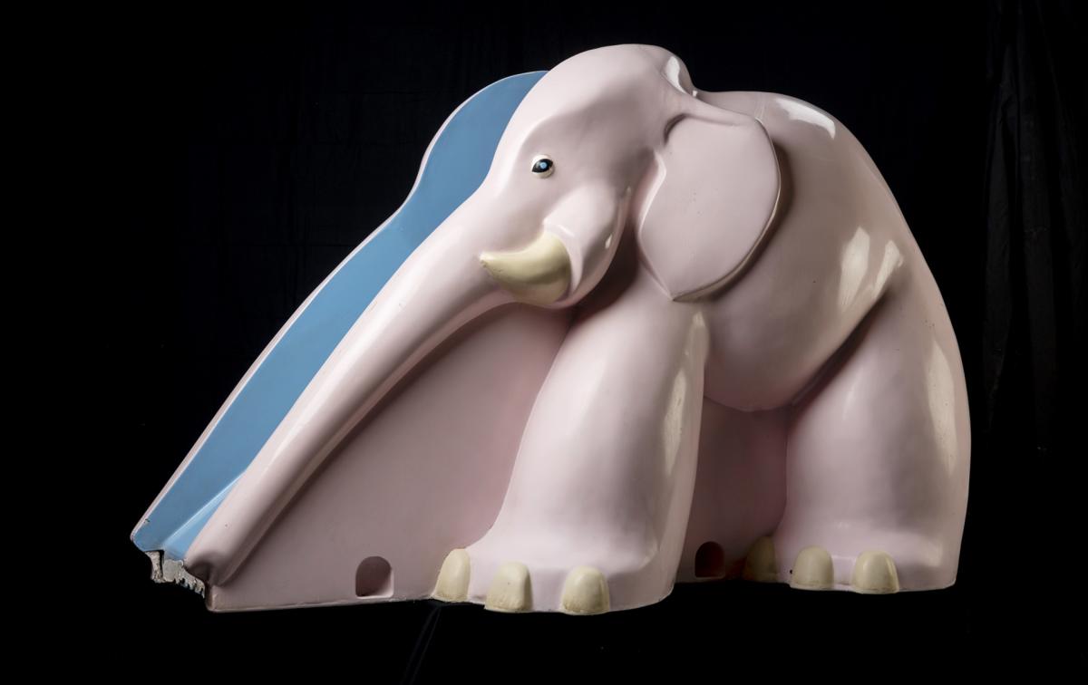 A pink elephant slide for children.