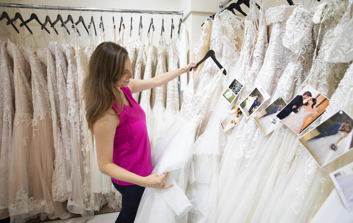 Bride looking at dresses at La Reve Bridal Boutique.