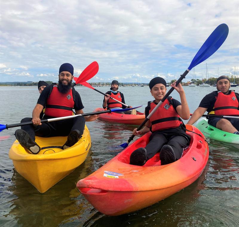 people in kayaks on water