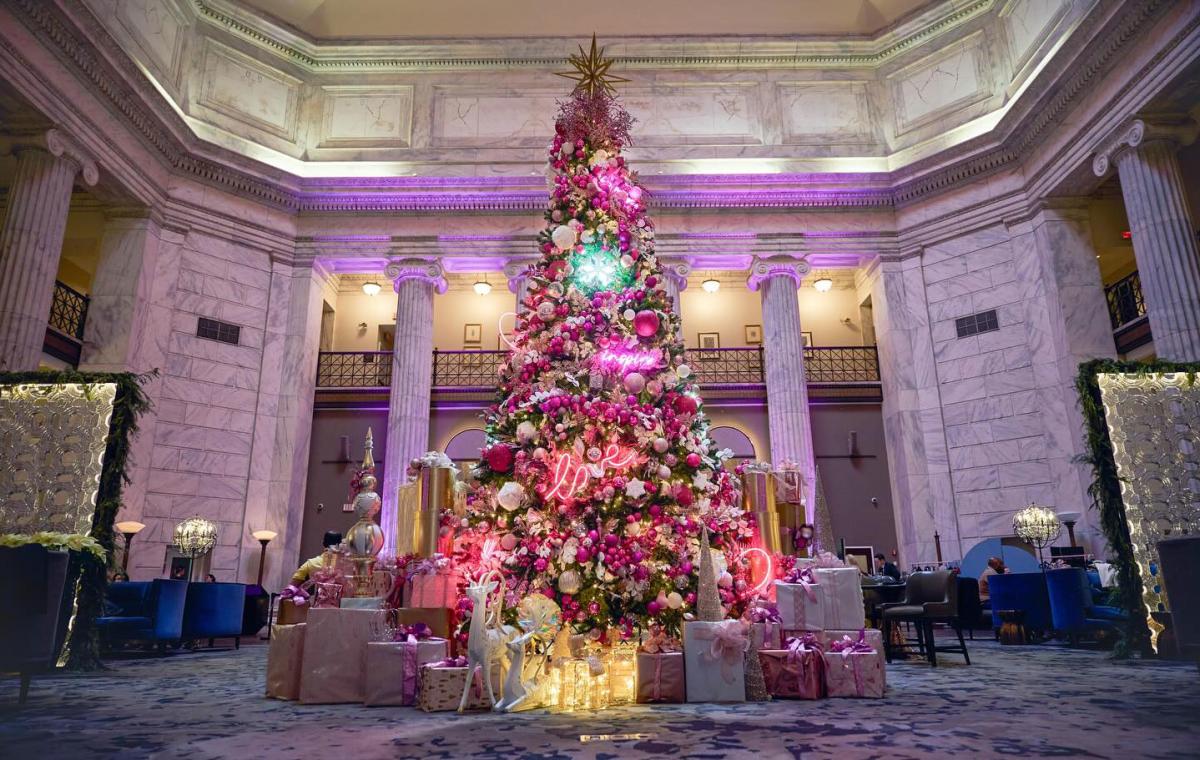 Christmas Tree decorated with lights ornaments and gifts in the Hotel Lobby