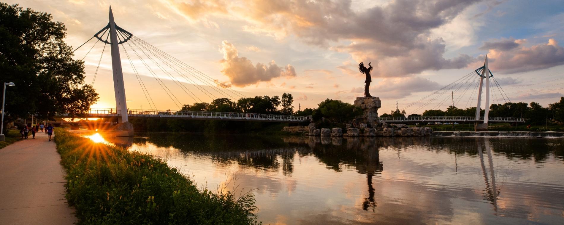 Wide angle shot of the Keeper of the Plains at dusk from the south bank of the river in Wichita