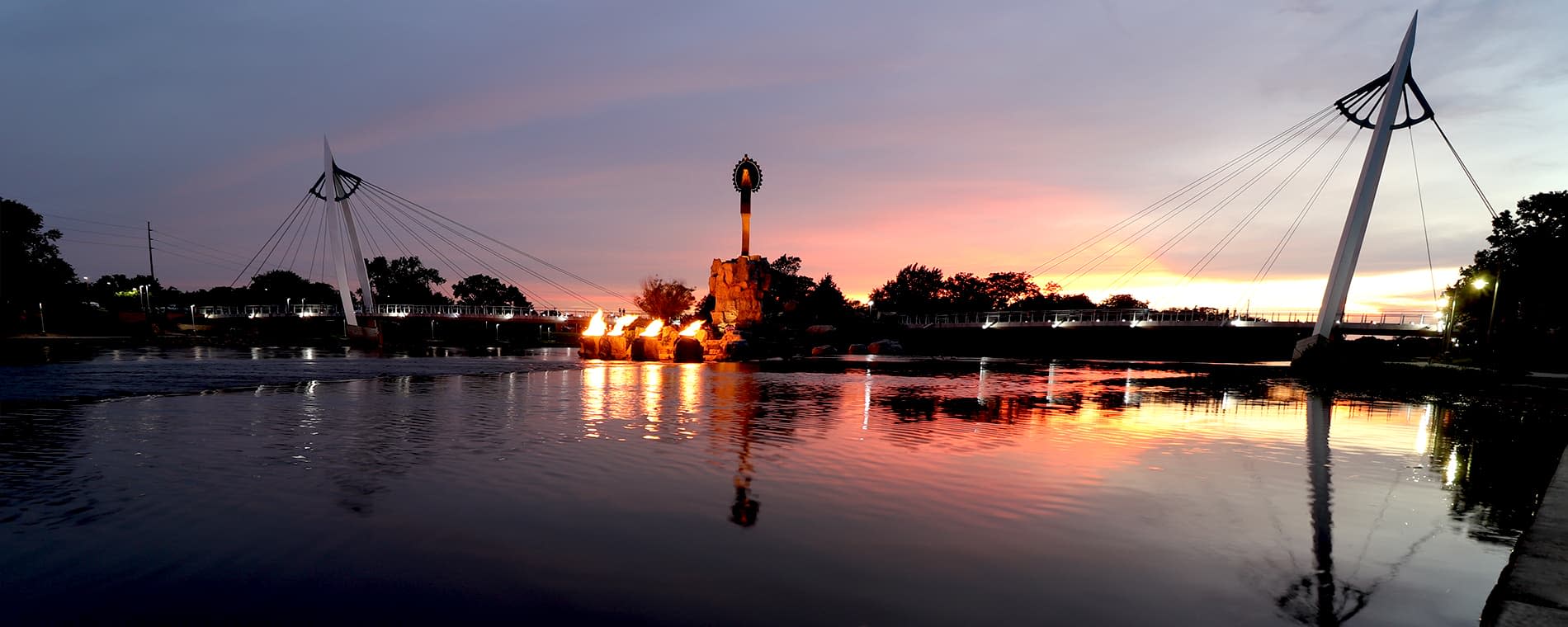 Keeper of the Plains at dusk with lit firepots