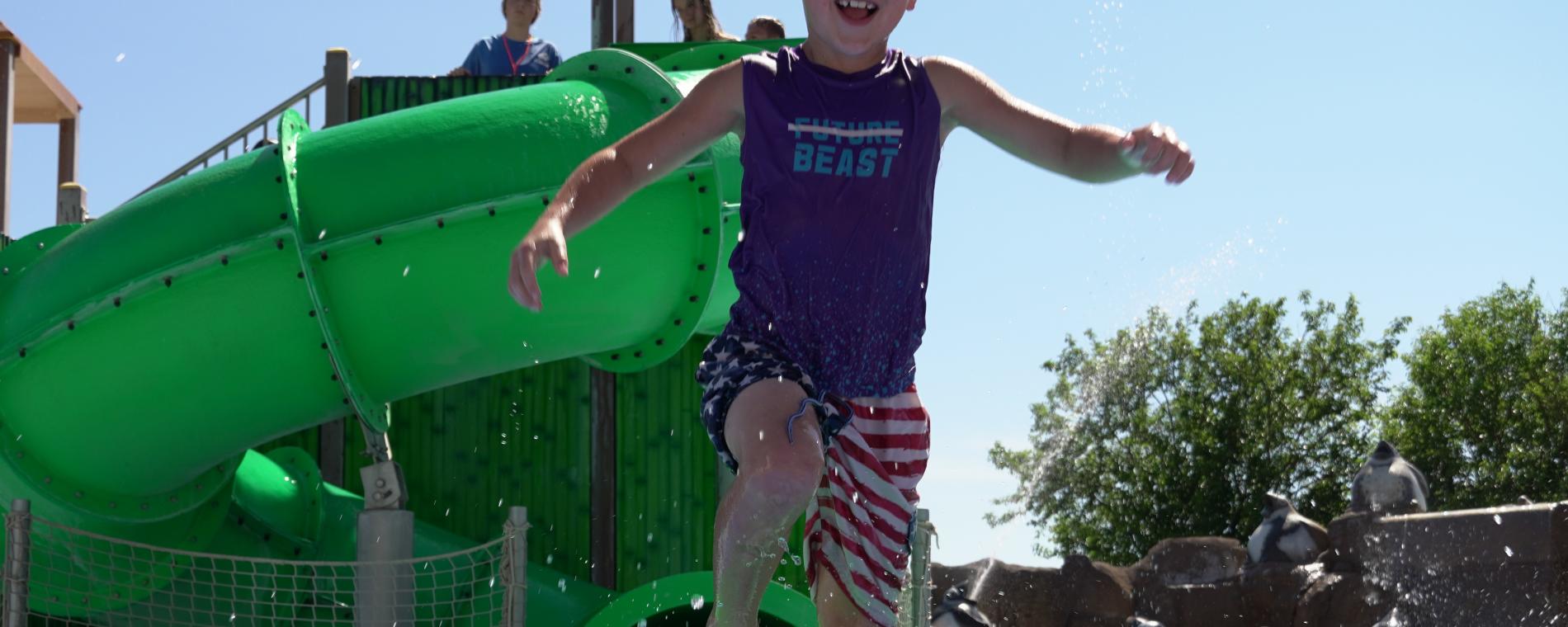 Boy on slide at splash park