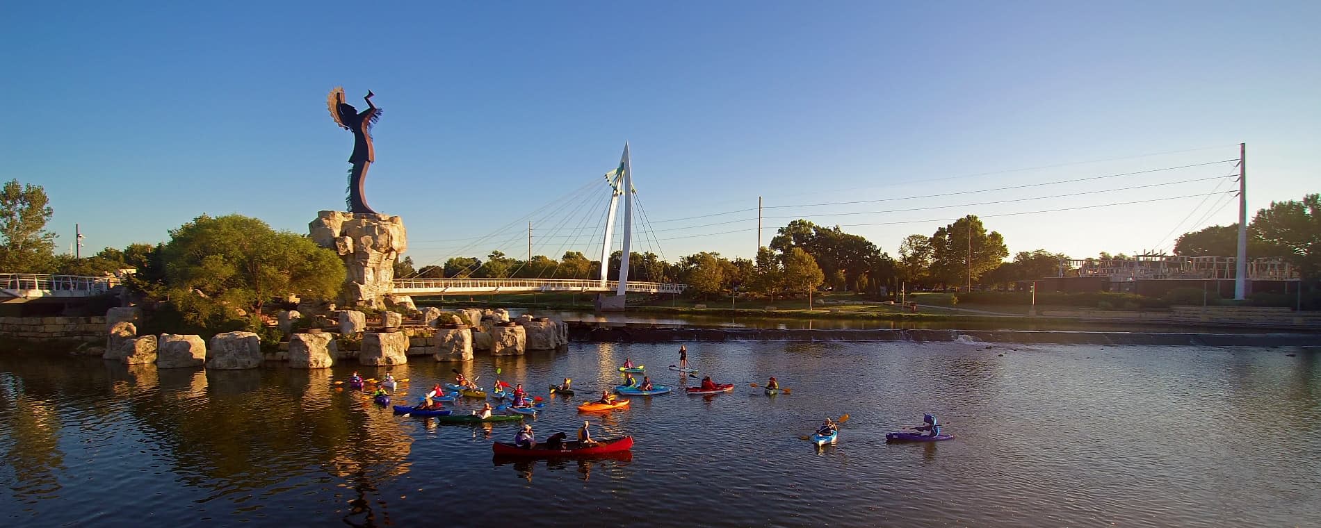 kayaks on the arkansas river near the keeper of the plains in wichita