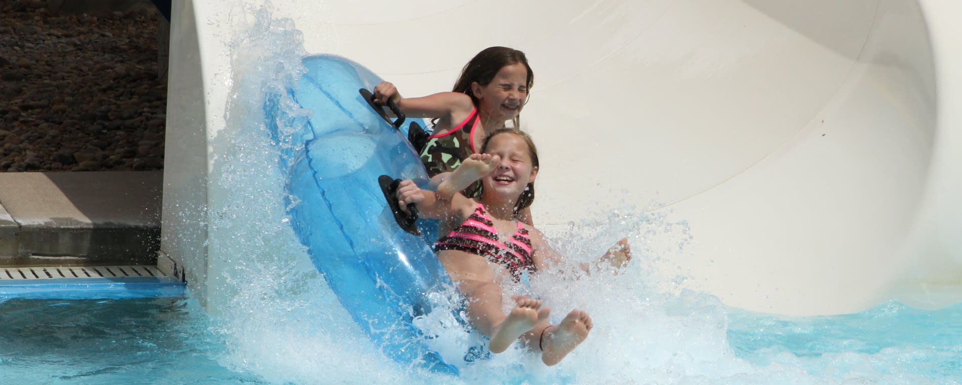 Two Girls Exiting a Waterslide at Rock River Rapids